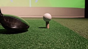 Golf driving practice session at indoor facility with simulator and ball - Powered by Shutterstock - Get 15% off with code: PIKWIZARD15