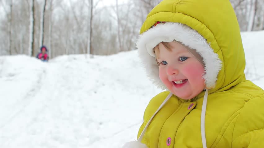Children on sleds laughingly slide down a snow slide. High quality 4k footage