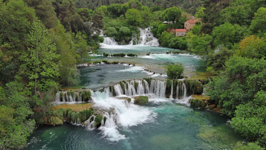 Aerial view of beautiful Krka Waterfalls in Krka National Park, green foliage and turquoise water, Croatia, 4k