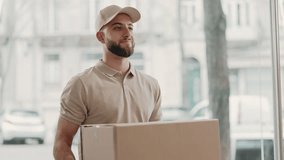 A bearded courier in a cap smiles while handing over a large package to a client, representing prompt and friendly delivery service. - Powered by Shutterstock - Get 15% off with code: PIKWIZARD15