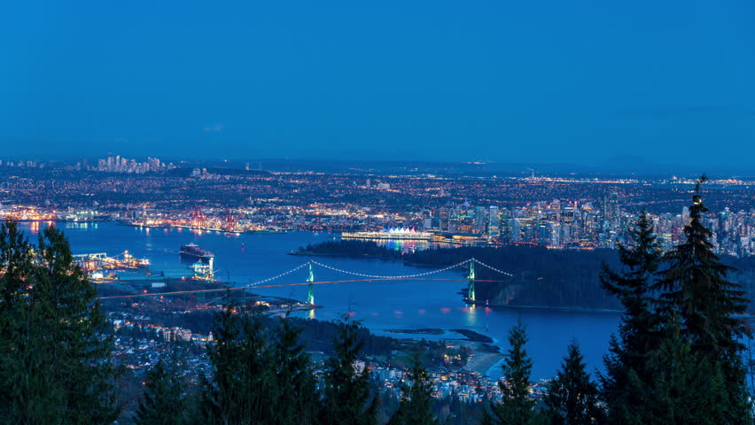 Vancouver city downtown panorama at night. Vancouver Harbour marina. Lions Gate Bridge, British Columbia, Canada. Time-lapse view.