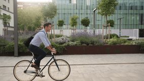 Elegant man going to work to the office by bicycle - Sustainable commuter transport the city  - Powered by Shutterstock - Get 15% off with code: PIKWIZARD15
