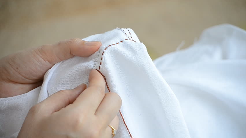 woman embroidery white cloth