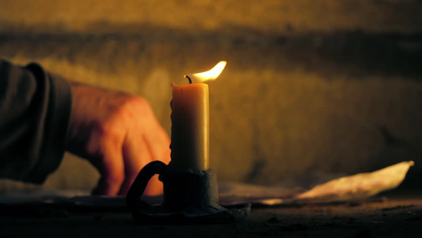 Writing with quill on parchment by candlelight medium zoom shot selective focus