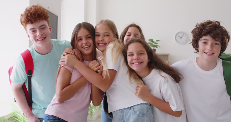 Excited happy teen friends group common gathering hug, young fellow people having fun, students reunion, friendly school club team community mates meeting, teenagers together enjoy common union joy
