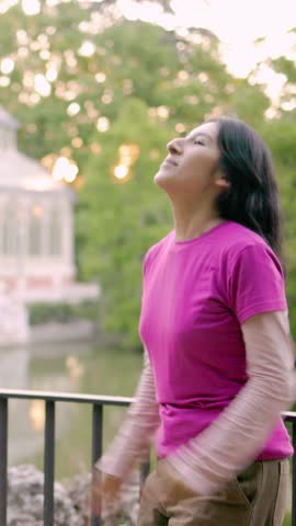 Young latin woman dancing in slow motion, showcasing grace and balance. Madrid, Palacio de Cristal