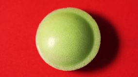 Green candy on red background. Close-up of the candy's surface structure. - Powered by Shutterstock - Get 15% off with code: PIKWIZARD15