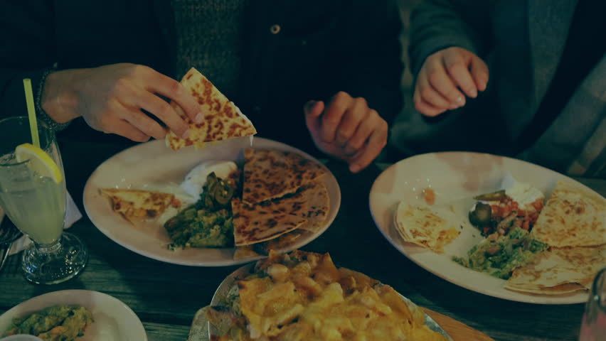 Couple hands and food while they eat. 