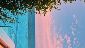 Vertical, Luxury Resort Hotel with Infinity Swimming Pool with Amazing Sunrise Sea View Blue Sky and Pink Clouds, Slow Motion Nobody Relax Pool Beach Ocean Colorful Dawn Sky, Journey., Relax. - Powered by Shutterstock - Get 15% off with code: PIKWIZARD15