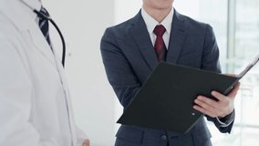 A doctor and a salesman talking - Powered by Shutterstock - Get 15% off with code: PIKWIZARD15