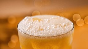 fresh sparkling orange drink pouring into glass with ice, close up. Defocused orange festive background - Powered by Shutterstock - Get 15% off with code: PIKWIZARD15