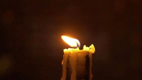 A solitary burning candle with a flickering flame, creating a warm and tranquil atmosphere in 4K slow motion 60fps - Powered by Shutterstock - Get 15% off with code: PIKWIZARD15