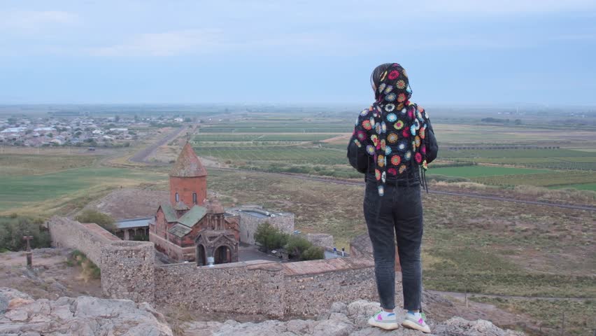 Happy tourist blogger on viewpoint by famous Khor Virap monastery.Khor Virap is an Armenian monastery located in the Ararat Plain in Armenia. Ararat Province, within the territory of ancient Artaxata