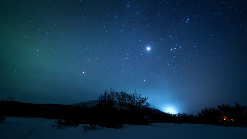 Tourist viewing hazy northern lights over Finland at night, serene atmosphere in dark skies as aurora dances and stars rotate