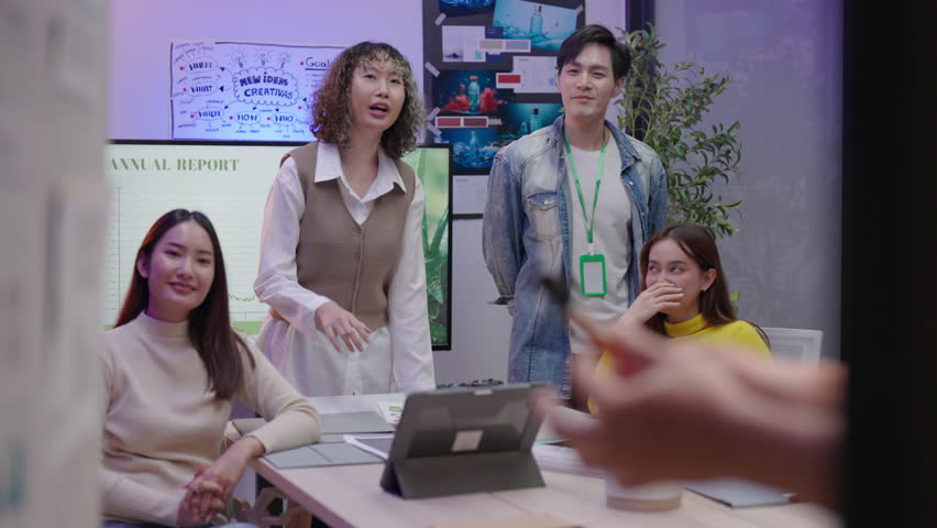 Group of young Asian professionals collaborating on a late-night project meeting in a modern office. Brainstorming innovative ideas for a new business venture. - Powered by Shutterstock - Get 15% off with code: PIKWIZARD15