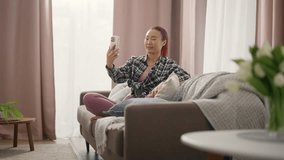 Video conference by smartphone or streaming in social media, Asian girl at home. Positive smiling woman calling by video call on mobile phone, blogger communicating with followers, mobile app using - Powered by Shutterstock - Get 15% off with code: PIKWIZARD15