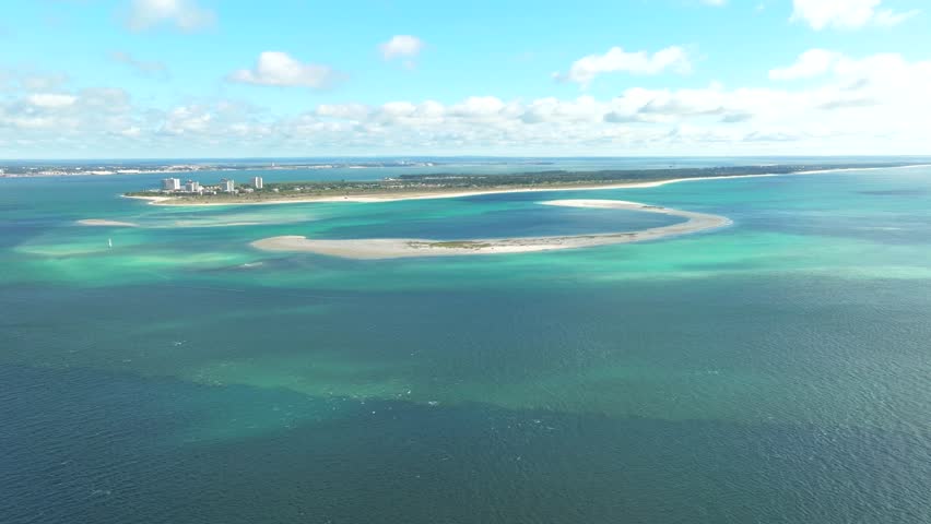 Drone flyover scenery of Troia Peninsula with sandbank surrounded by turquoise water, Portugal