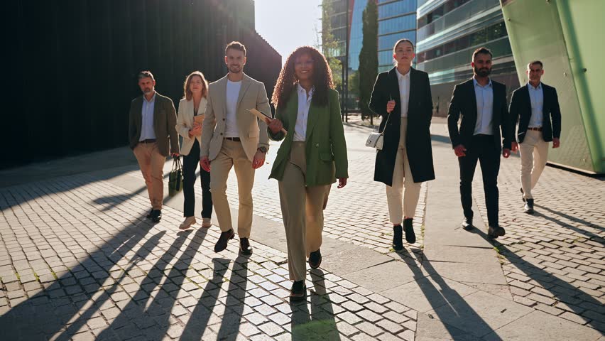 Modern Business People Team walking together with confidence and determination - Group of diverse professionals in the city