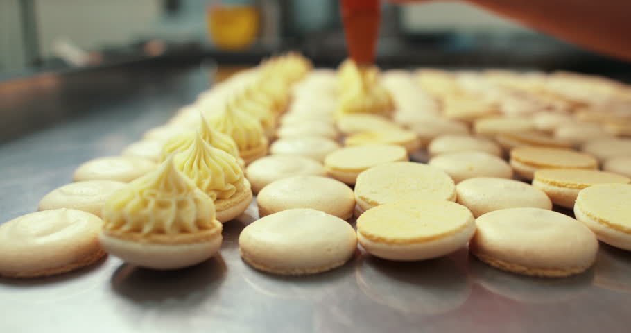 The process of making macarons. The footage shows precision, craftsmanship, and attention to detail, conveying the passion behind creating the perfect French desserts. Perfect for cooking projects, ba