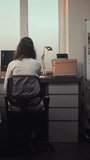 Female scientist takes off lab coat, turns off personal computer and leaves at the end of the working day. Archaeological science lab with advanced equipment, fossil bones and microscope. Vertical - Powered by Shutterstock - Get 15% off with code: PIKWIZARD15