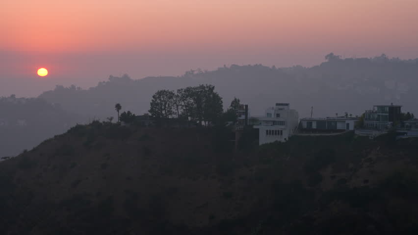 Dynamic panoramic sunset view over Runyon Canyon highlighting vibrant sky colors and urban landscape.