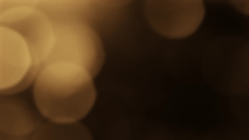 Floating gold lights create a dreamy and sophisticated scene on a dark background, ideal for holiday and premium themes with golden bokeh.