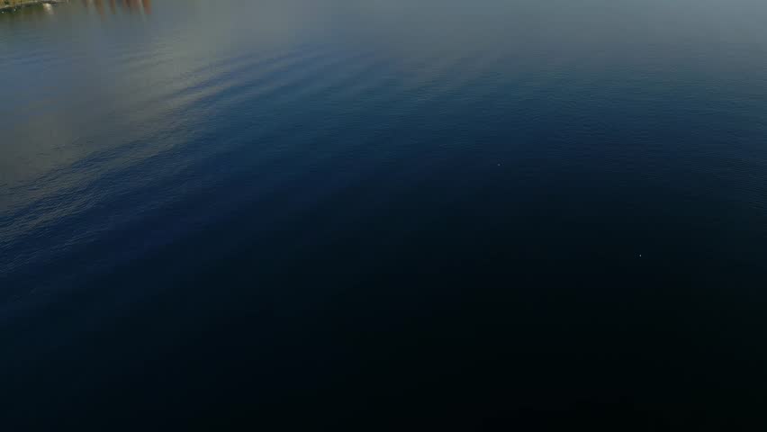 Reveal drone shot of Lake Geneva in Lavaux with autumn colors in Canton of Vaud Switzerland