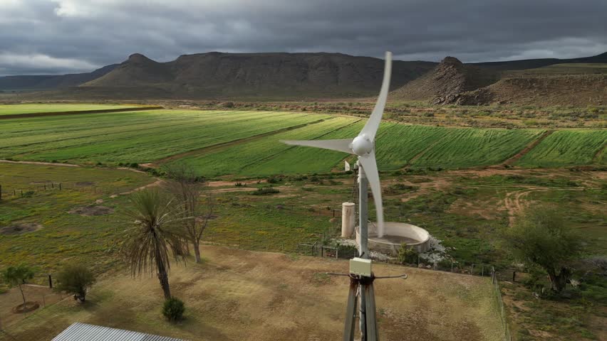 parallax shot of small wind turbine spinning, Northern Cape, South Africa