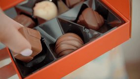 Woman Eat Yummy Delicious Chocolate Candies Praline. Sweet Food Dessert Praline. Mixed Chocolate Candy Box. Assortment Fine Chocolates Confectionery. Cocoa Confection.  Hand Grabbing Chocolate Bonbons - Powered by Shutterstock - Get 15% off with code: PIKWIZARD15
