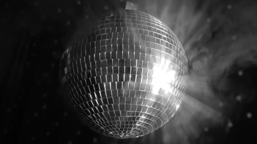 Reflective disco ball sparks joy in lively party atmosphere with shining lights in a vibrant dance setting