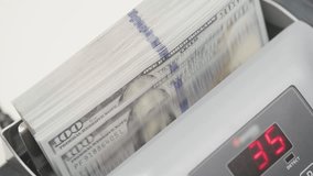 Stack of US Dollar Bills in Money Counting Machine with Digital Display - Powered by Shutterstock - Get 15% off with code: PIKWIZARD15