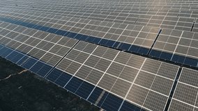 Aerial panning view solar panel farm in Siauliai city, Lithuania. Renewable energy in baltics, Europe union. Sustainable electric power plant with many rows of solar photovoltaic panels - Powered by Shutterstock - Get 15% off with code: PIKWIZARD15