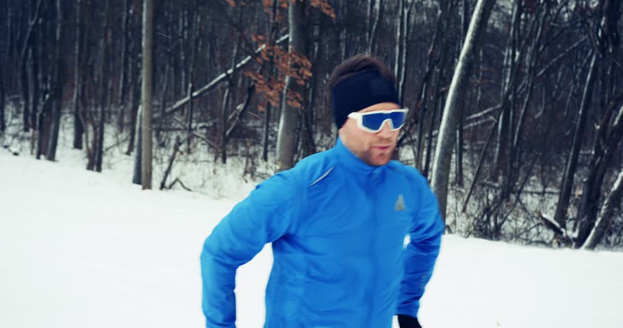 Focused cross-country skier on a scenic training trail in the woods