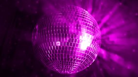 Bright pink disco ball spins and reflects colorful lights during a lively dance event at a local venue in the evening - Powered by Shutterstock - Get 15% off with code: PIKWIZARD15