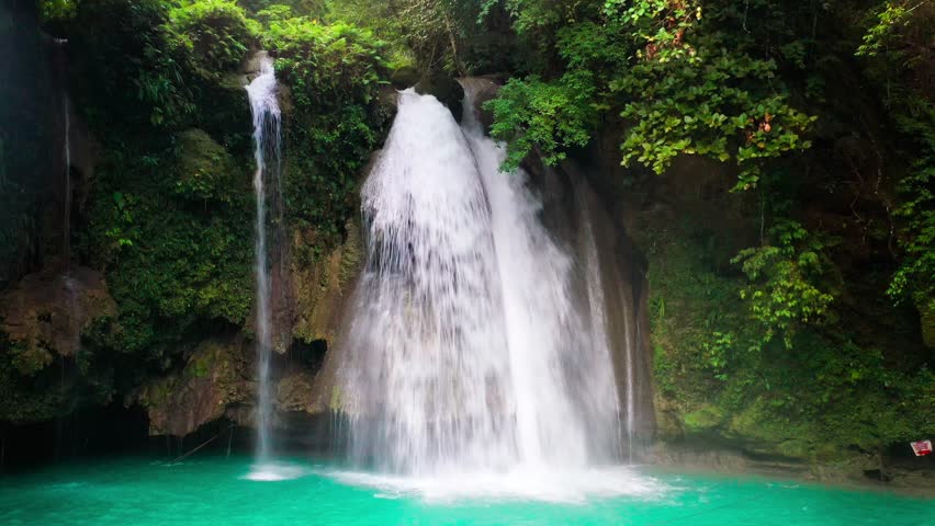 Aerial drone view Kawasan waterfalls in mountain gorge in the tropical jungle Philippines, Cebu. High quality 4k footage