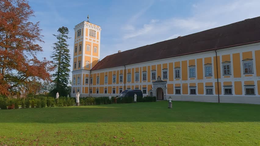 Picturesque autumn view of Tillysburg Castle. Fabulous evening view of old palace and green field of Golf Club Linz St. Florian, Austria, Europe. 4K video (Ultra High Definition).