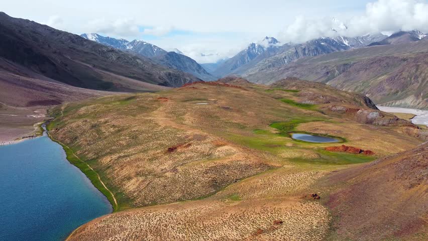 Aerial view of chandratal lake surrounded by snow-capped Himalayan mountains at chandratal in lahaul and spiti valley himachal pradesh, India.