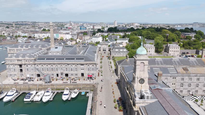 Aerial view of the central boulevard in Royal William Yard, featuring historic buildings and greenery in Plymouth, UK.