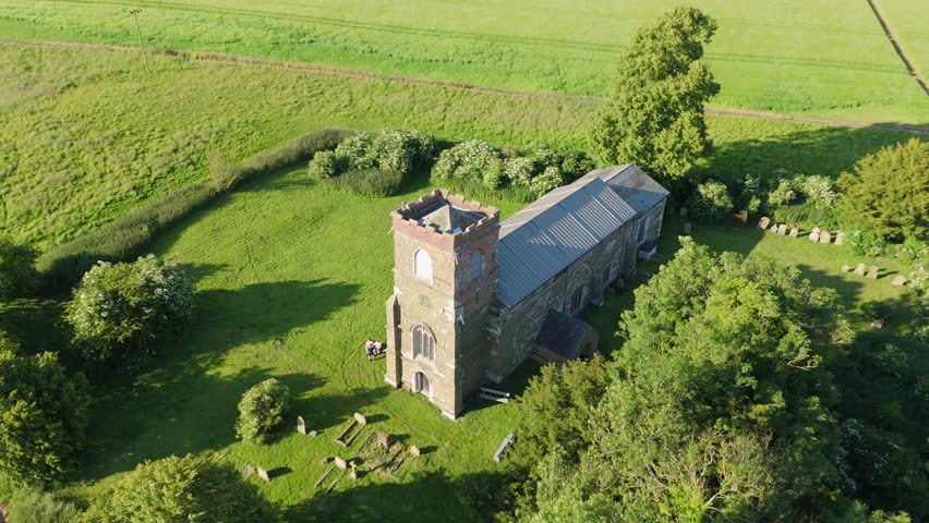 Aerial drone footage of a small Lincolnshire village called Burwell in the UK. Typical English rural village scene. St Michael