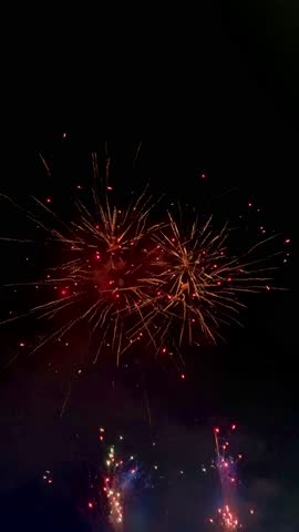 4k footage of beautiful sparkling fireworks show and play at night sky. Fireworks are often done to celebrate new year, christmas, theme park, or special events. Happy New Year.