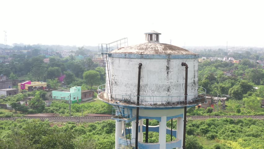 Close aerial view of a village water tank in India, showcasing rural infrastructure and natural surroundings.