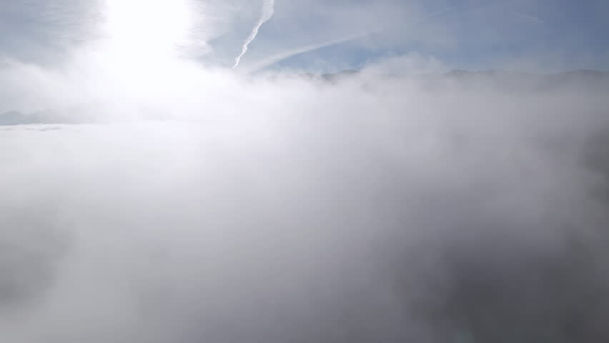 Flight over of fluffy white clouds background