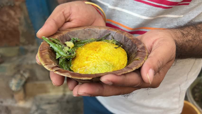 Closeup view featuring round shaped dhoklas on leaf plate by a roadside stall.