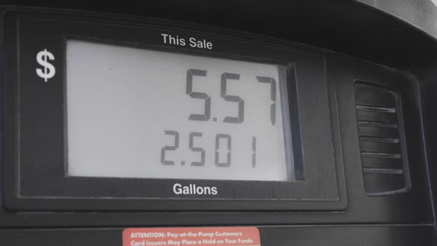 high gas price close up of meter counter count gallon gas fuel refill to vehicle transportation at gasoline gas station near highway