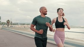 Couple, man and woman running or jogging at the seaside for a healthy lifestyle. Street work out concept, couple goals and motivation. Happy fit people are cheerfully doing sports - Powered by Shutterstock - Get 15% off with code: PIKWIZARD15