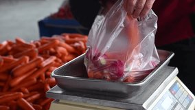 A vendor weighs vegetables at the local produce market. - Powered by Shutterstock - Get 15% off with code: PIKWIZARD15