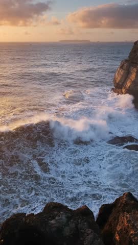 Ocean cliff rock by the sea at sunset in Cabo Carvoeiro, Peniche, Portugal with crashing waves