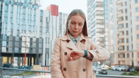 Upset mature woman standing outside office looking around waiting for business meeting impatient girl dissatisfied looks at the wristwatch, checks time on watch annoyed by being late lateness concept. - Powered by Shutterstock - Get 15% off with code: PIKWIZARD15