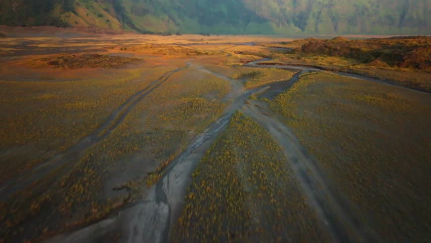 Aerial Shot Of Bromo , Drone Flying Over Landscape during Sunset at Pasir Berbisik - Java, Indonesia