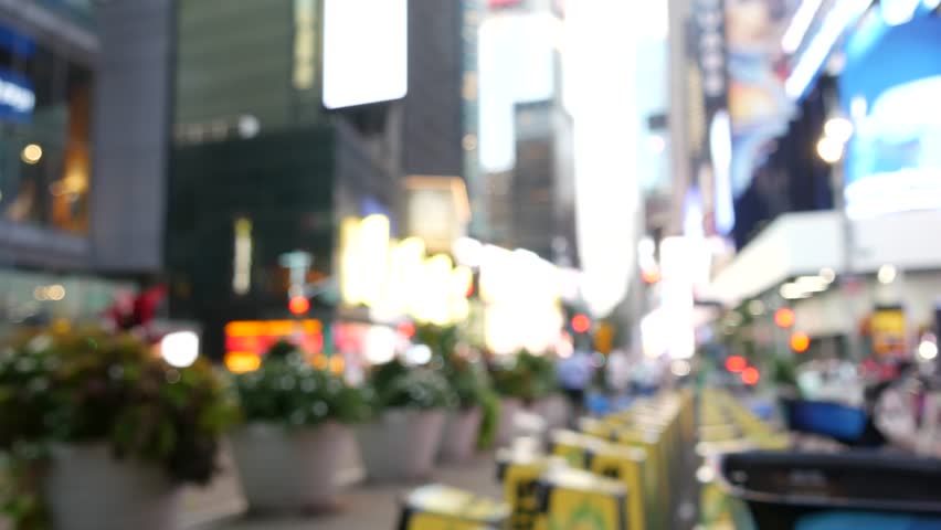 New York City Times Square, Manhattan Midtown Broadway street, USA. American NYC urban life. Defocused people pedestrians. Advertising signs, commercial ads, illuminated billboard screens glowing.